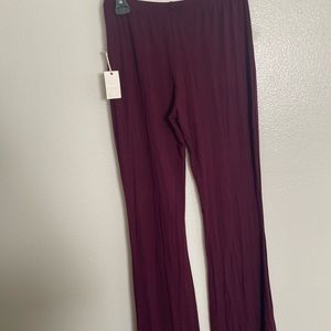 Dark purple bell bottom leggings with tag from FOREVER 21 in a size Medium
